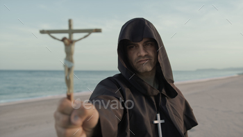 Monk With Statuette Of Jesus In His Hand Prays