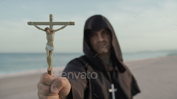 Monk With Statuette Of Jesus In His Hand Prays