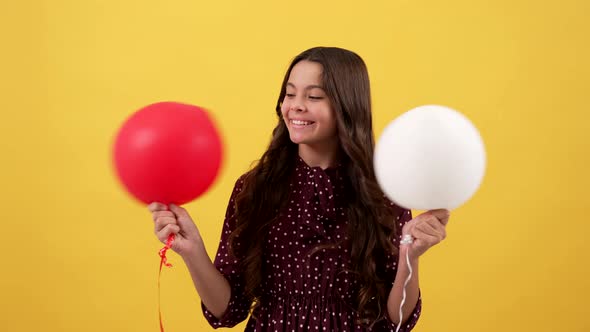 Happy Child Holding Party Balloons on Yellow Background Childhood