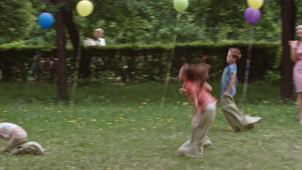 Funny Kids Jumping in Sacks alt