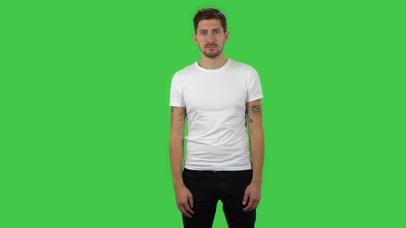 Confident Guy Is Looking Straight and Smiling, Green Screen