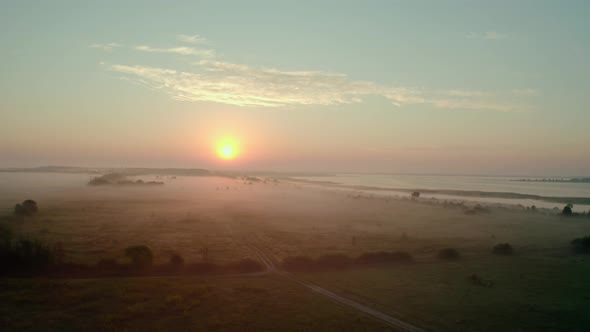 Aerial Drone View. Beautiful Misty Dawn in the Spring on the Lake. and Rural Road V2