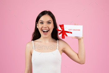 Excited woman showing a gift voucher card