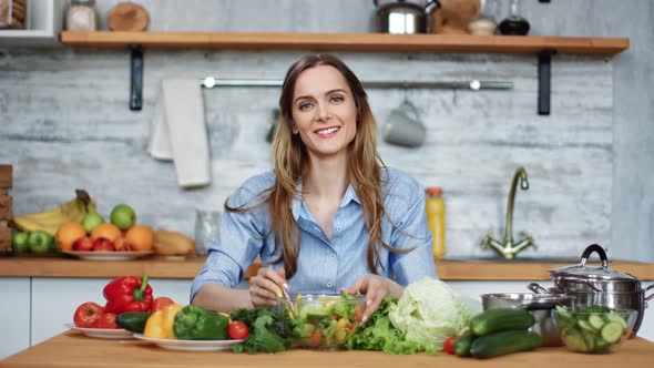 Portrait of Smiling Young Woman Posing with Fresh Vegetarian Salad