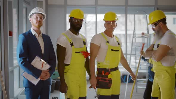 Portrait of Diverse Team of Professional Builders at Construction Site