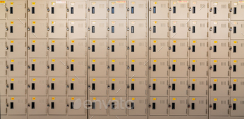 Closeup beige locker with lock and numbered yellow tags at locker room. Locker for safety