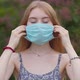 Beautiful young girl, blonde puts on a medical mask - VideoHive Item for Sale