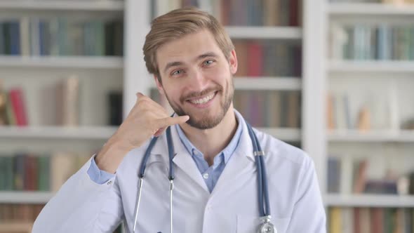 Portrait of Doctor Showing Call Me Sign