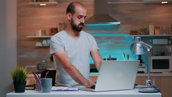 Freelancer Writing Notes in Notebook From Laptop