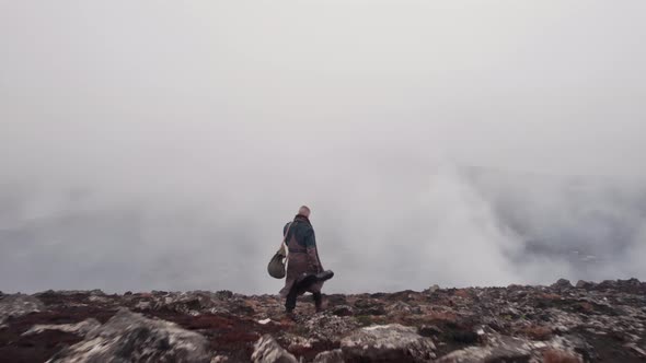 Drone Of Man In Greatcoat Walking Through Misty Landscape