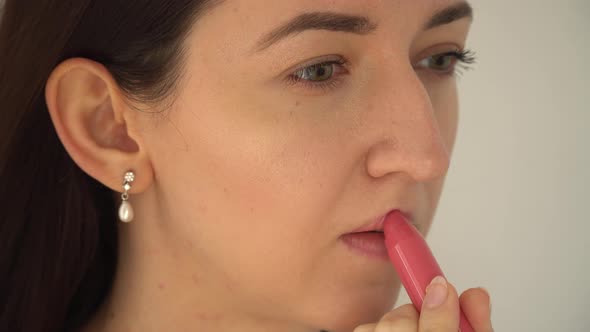 Young Girl Paints Lips Lipstick