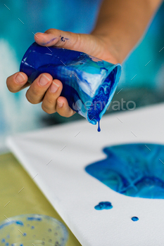 Artistic Blue Paint Pouring on Canvas