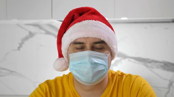 Man in Santa Claus Hat Wearing Medical Mask Celebrate Christmas at Home