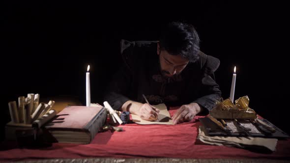 Medieval man writing letters. Historical video.