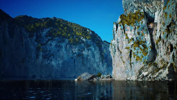 Rocky Cliffs in the Ocean at Sunny Day