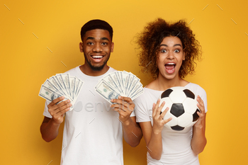Excited african-american couple enjoying sport bet win