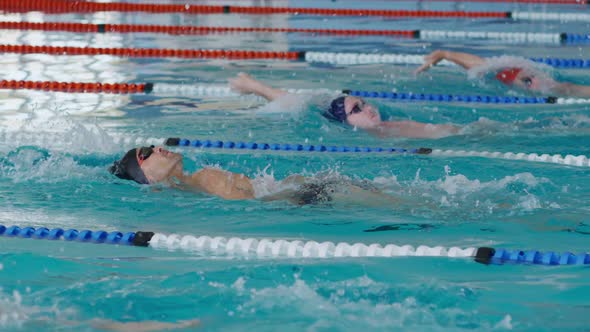 Swimmers swimming into the pool