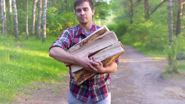 Portrait of a Man in a Shirt Carrying Wood Chipped Birch Logs Slow Mo