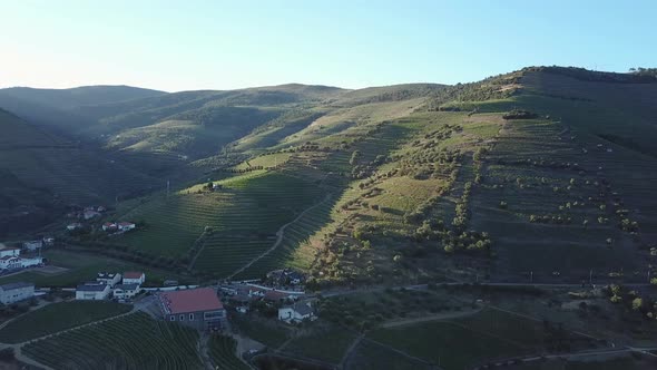 Panning across a beautiful scene of the Douro Valley in Portugal with communities below lit by the s