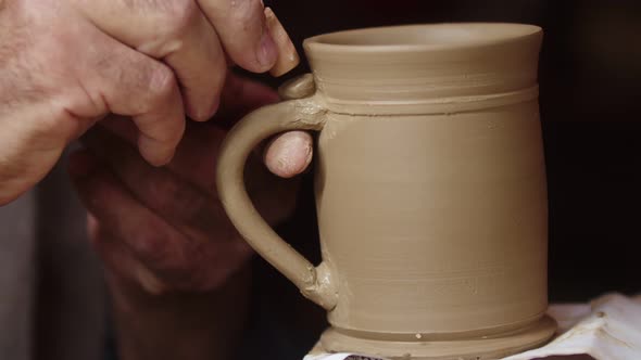 Potter Uses Brush While Processing Ceramics in Workshop Closeup