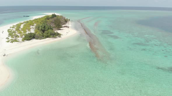 Aerial: Flying over idyllic atoll, scenic travel destination in Indonesia