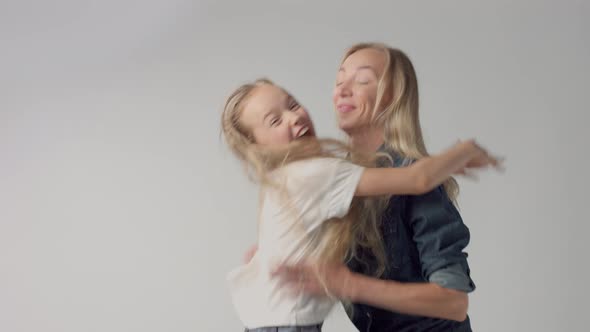 Young Girl Jumps on Hands To Mum and Smiling Both