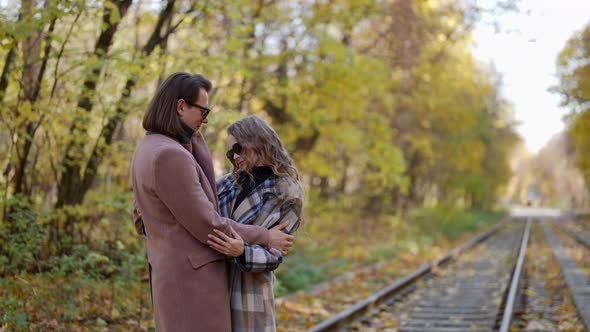 Romantic Date in Autumn Day Man and Woman are Embracing