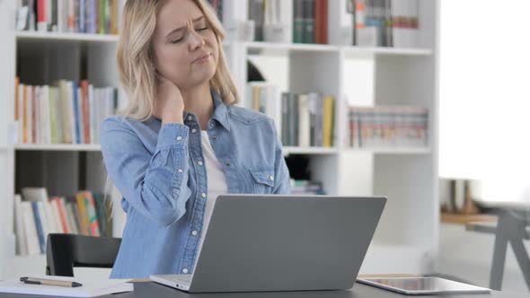 Tired Young Woman with Neck Pain Working on Laptop