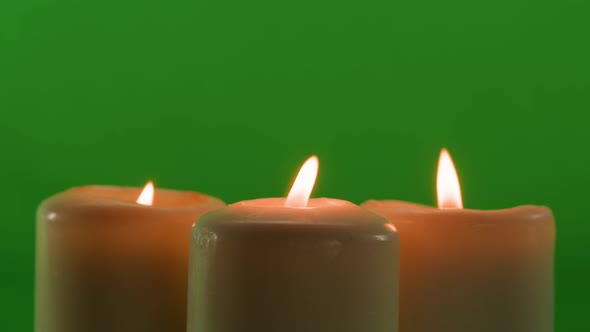 Burning Wax Candles on Green Chroma Key Background