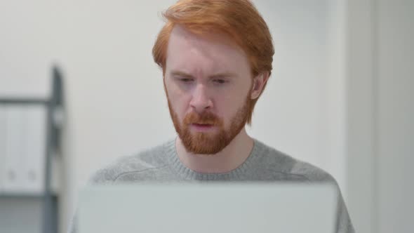 Portrait of Redhead Man Having Loss While Using Laptop 