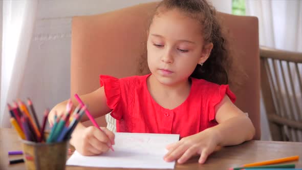 Happy Little Girl or Cute Primary Child School Child of 7-8 Years Old at Home Relaxing Sits in House