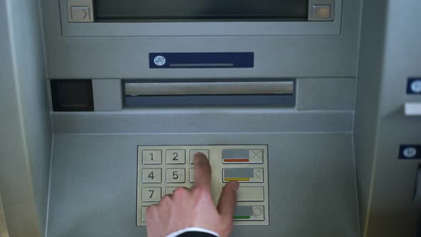 Male Hand Entering Pin Code on ATM and Withdrawing Euro Money Cash, Top View