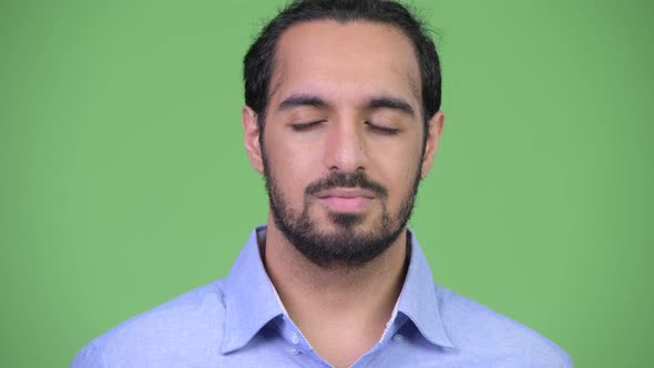 Young Handsome Bearded Indian Businessman Relaxing with Eyes Closed