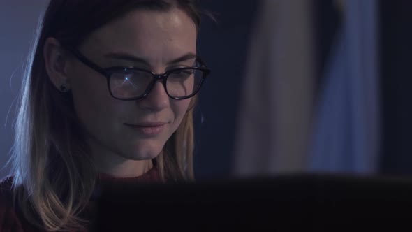 Portrait of Girl Sitting in Front of Monitor Screen While Working at Computer with Glasses, Working
