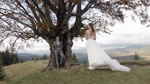 Lovely Caucasian Wedding Couple Newlyweds Family Bride Groom Stay Together on Mountain Slope Hill