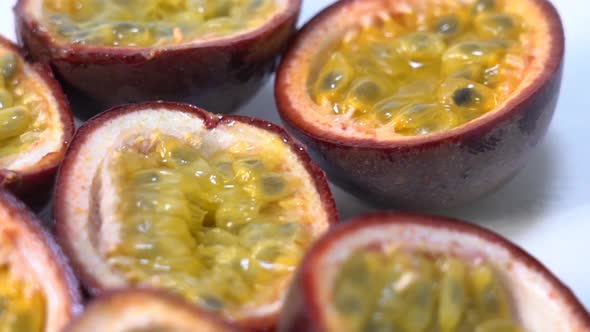 Split exotic passion fruit on white table