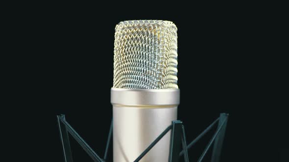 Studio Microphone with Spider Rotates on a Black Background