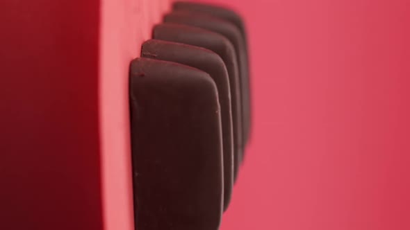 Vertical video, Close up: Composition of chocolate and candies on a red background