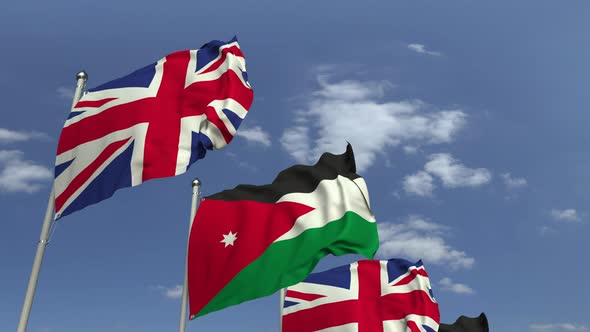 Waving Flags of Jordan and the UK on Sky Background alt