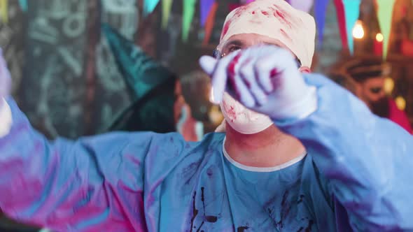 Adult Man at a Halloween Party Dancing in the Costume of Mad Surgeon