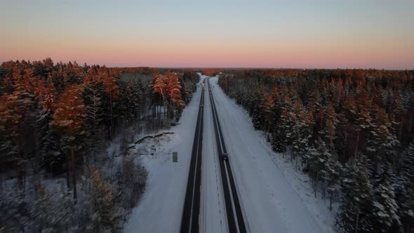 Aircraft flying along highway, dusk, wintertime Sweden