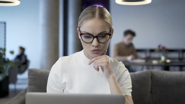 Serious And Thoughtful Face Of Businesswoman