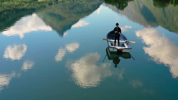 Woman on the Boat Catches a Fish on Spinning in Norway