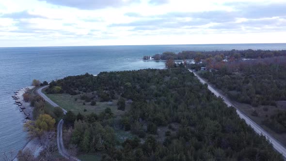 Aerial over a lake tilting up from coast line day time 1