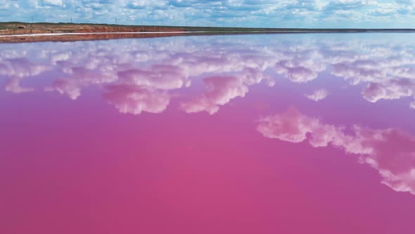 Epic Aerial View of Colorful Pink Salt Lake and Clouds Reflection