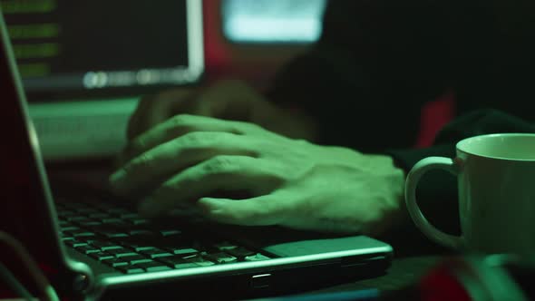 Professional Hacker Typing on Keyboard at Night Closeup of Man Hands Trying to Break Password Using