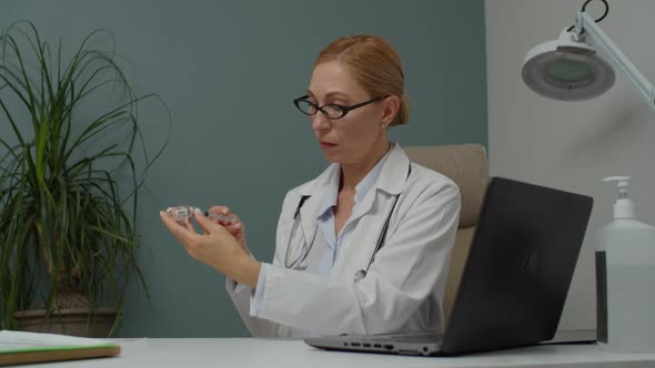 Female Doctor Filling Syringe with Medicine or Vaccine Indoors