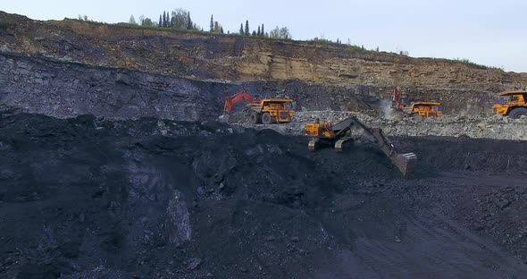 Yellow Excavator Digs Coal