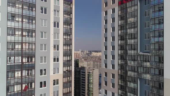 Aerial view of two new modern high-rise buildings with a playground and parking lot 15