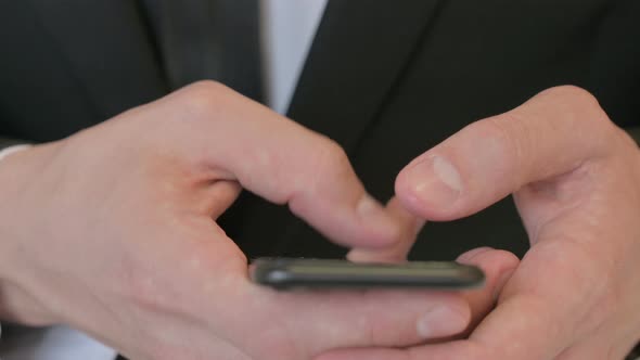 Close Up of Middle Aged Businessman Using Smartphone Mobile